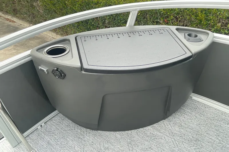 Slide: The Image of 2026 Sun Tracker Bass Buggy 18 DLX boat console with cup holders and measurement panel. - 22