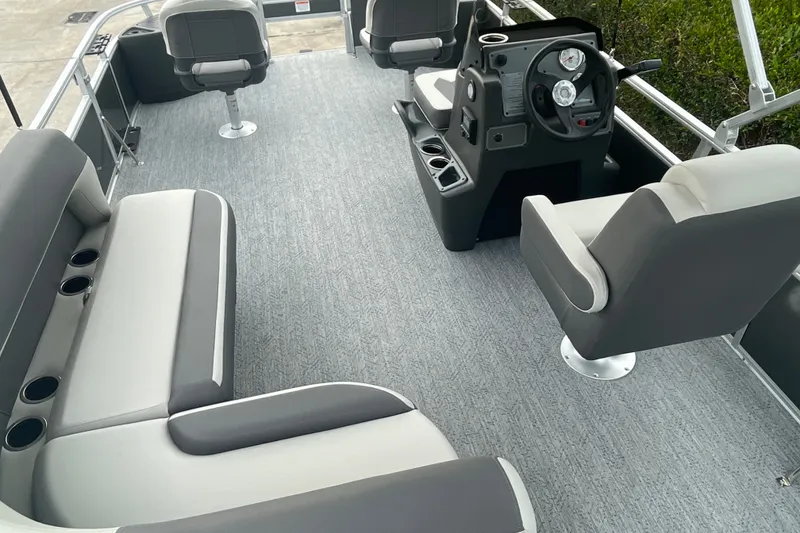 Slide: The Image of 2026 Sun Tracker Bass Buggy 18 DLX pontoon boat interior with seating and steering console. - 11
