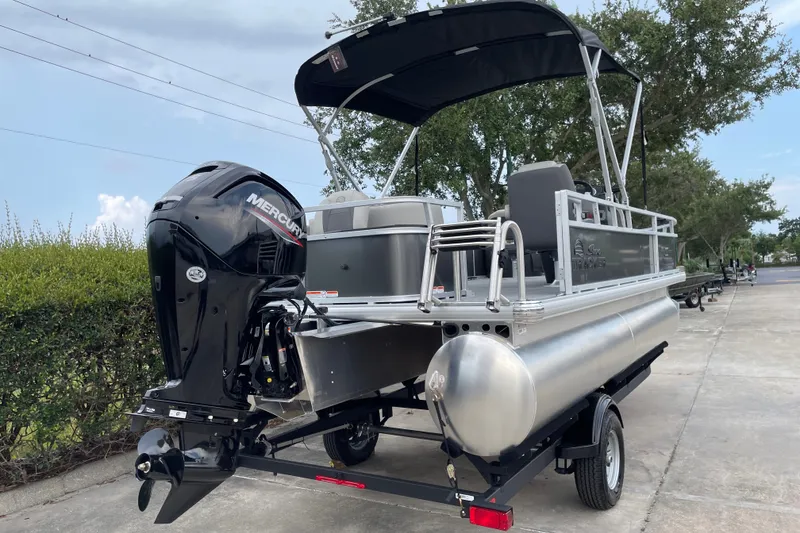 Slide: The Image of 2026 Sun Tracker Bass Buggy 18 DLX pontoon boat with Mercury outboard motor. - 7