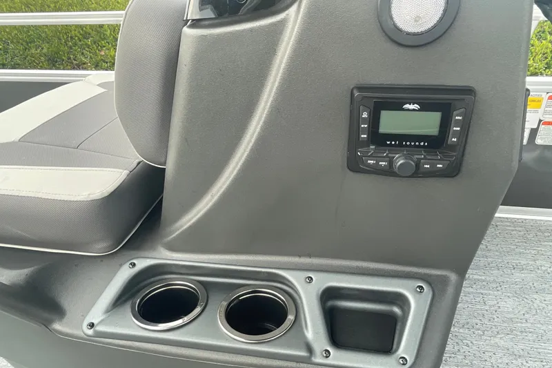Slide: The Image of 2026 Sun Tracker Bass Buggy 18 DLX console with stereo system and cup holders. - 14