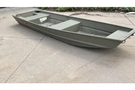 The Image of 2026 Tracker Grizzly 14 Jon boat on concrete surface, showcasing its sturdy design. - 0