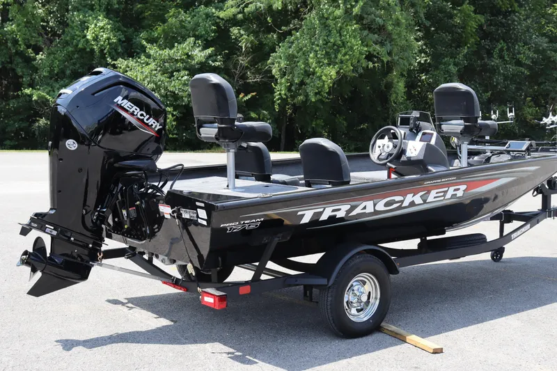 Slide: The Image of 2026 Tracker Pro Team 175 Crappie Edition boat with Mercury engine, parked outdoors. - 7