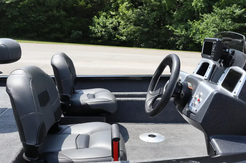 Slide: The Image of 2026 Tracker Pro Team 175 Crappie Edition boat interior with steering wheel and seats. - 15