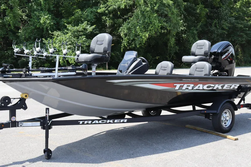 Slide: The Image of 2026 Tracker Pro Team 175 Crappie Edition boat on trailer, parked outdoors. - 2