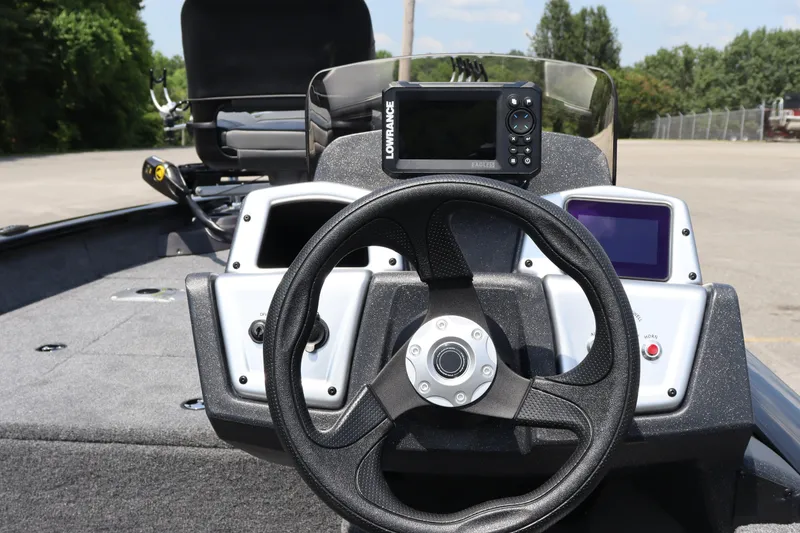 Slide: The Image of 2026 Tracker Pro Team 175 Crappie Edition boat dashboard with steering wheel and electronics. - 16