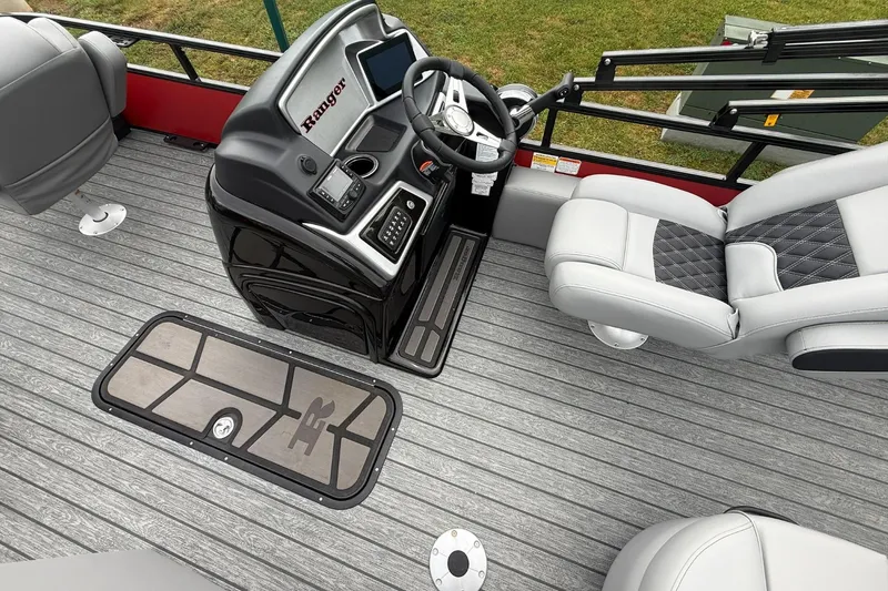 Slide: The Image of Interior of 2026 Ranger 223F boat with modern steering console and seating. - 6