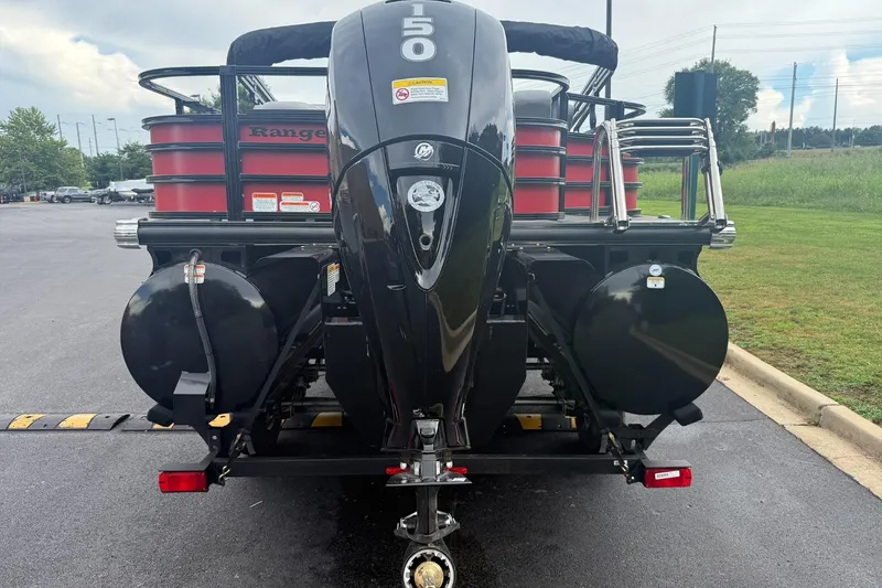 Slide: The Image of 2026 Ranger 223F boat with powerful outboard motor, parked on asphalt near grassy area. - 3