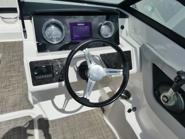 Slide: The Image of The image shows the cockpit of a 2021 Sea Ray SPX 190 Outboard with a modern steering wheel and instruments. - 7