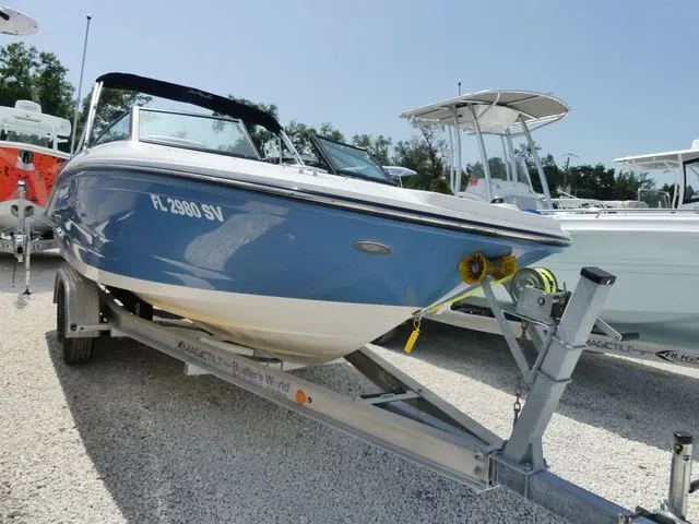 Slide: The Image of A blue and white 2021 Sea Ray SPX 190 Outboard boat on a trailer. - 3