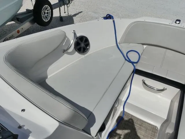 Slide: The Image of Interior view of a Sea Ray SPX 190 Outboard with gray upholstery and a blue rope. - 13