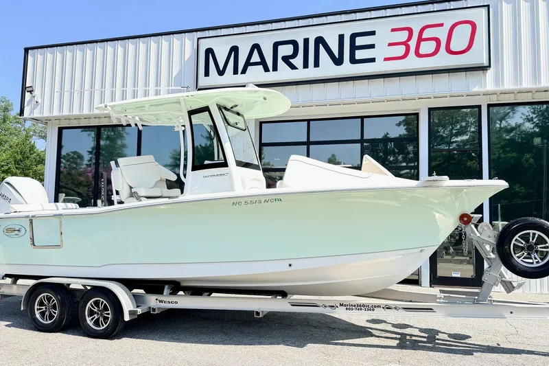 The Image of 2024 Sea Hunt Ultra 239 SE boat on trailer outside Marine 360 dealership. - 1