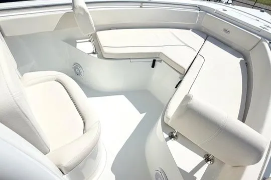 Slide: The Image of 2024 Sea Hunt Ultra 239 SE boat interior with white cushioned seating. - 27