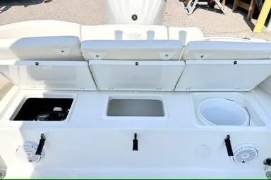 Slide: The Image of 2024 Sea Hunt Ultra 239 SE boat interior with storage compartments and seating. - 7