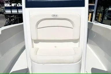 Slide: The Image of 2024 Sea Hunt Ultra 239 SE boat interior with cushioned seating. - 12