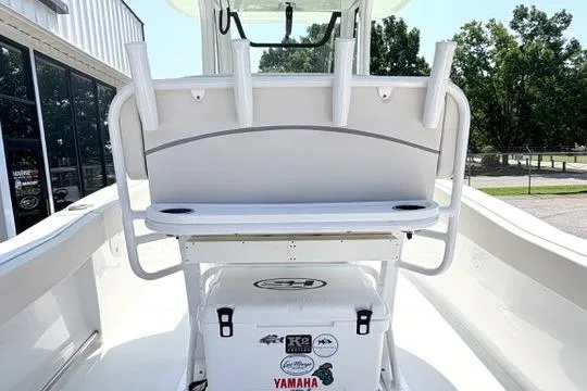 Slide: The Image of 2024 Sea Hunt Ultra 239 SE boat interior with rod holders and cooler. - 16