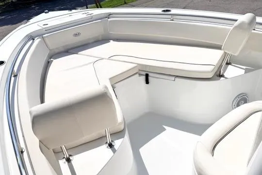 Slide: The Image of 2024 Sea Hunt Ultra 239 SE boat interior with cushioned seating and sleek design. - 24