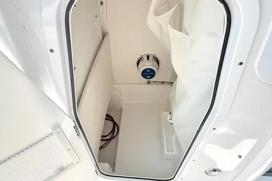 Slide: The Image of 2024 Sea Hunt Ultra 239 SE storage compartment with speaker and white interior. - 29