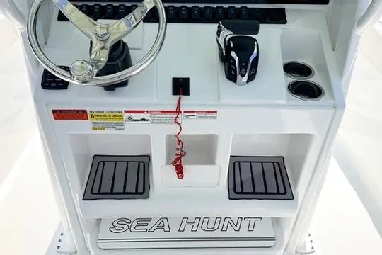 Slide: The Image of 2024 Sea Hunt Ultra 239 SE boat console with steering wheel and controls. - 19