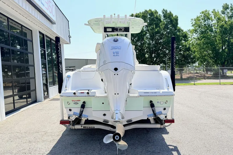 Slide: The Image of 2024 Sea Hunt Ultra 239 SE boat with powerful outboard motor, parked outside dealership. - 3