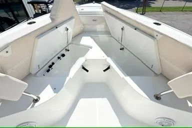 Slide: The Image of 2024 Sea Hunt Ultra 239 SE boat interior with spacious seating and storage compartments. - 10