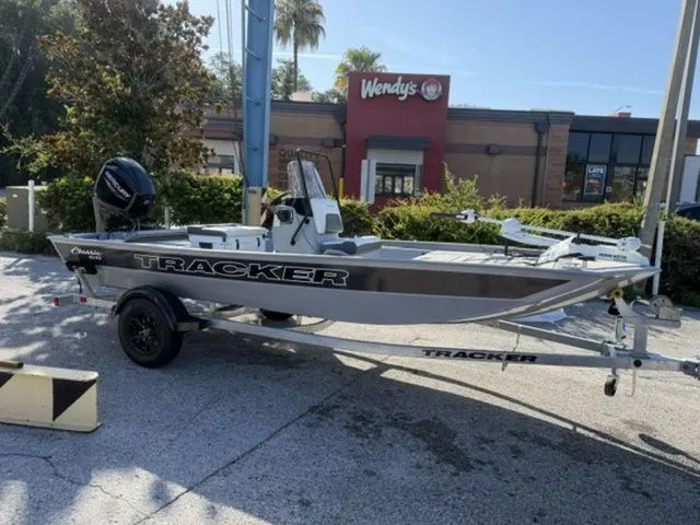 The Image of A 2027 Tracker Bass Tracker Classic CC boat on a trailer in front of a fast-food restaurant. - 1
