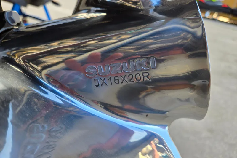 Slide: The Image of Close-up of a Suzuki propeller with model number 3X16X20R, reflecting light. - 18