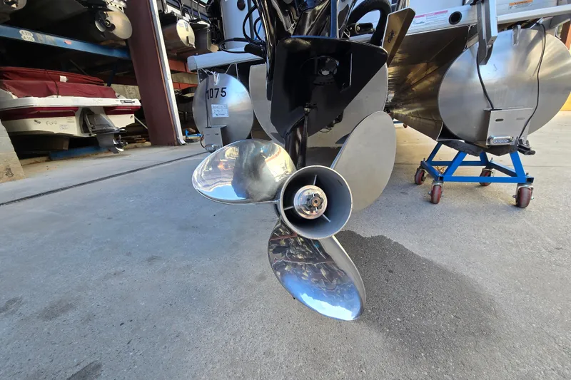 Slide: The Image of 2024 Godfrey Sweetwater 2486 SB boat propeller in storage, showcasing shiny metal blades. - 9