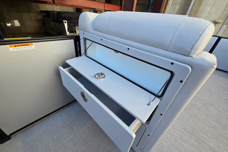 Slide: The Image of 2024 Godfrey Sweetwater 2486 SB boat interior with open storage compartment and seating. - 28