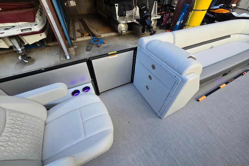 Slide: The Image of Interior of 2024 Godfrey Sweetwater 2486 SB pontoon boat with plush seating and storage. - 26