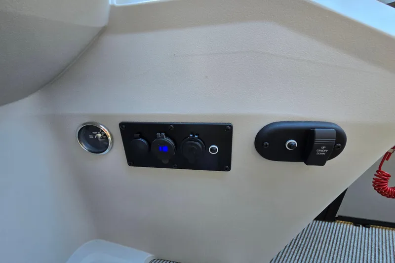 Slide: The Image of Control panel of 2024 Godfrey Sweetwater 2486 SB boat with switches and gauge. - 50