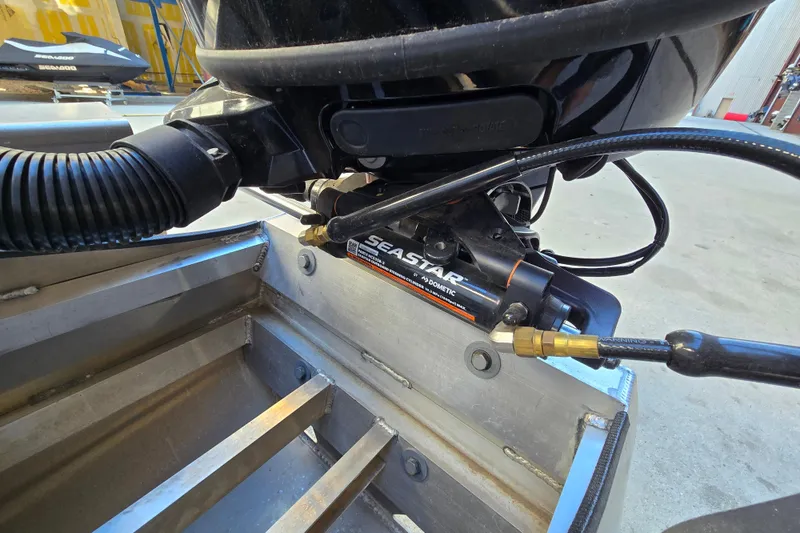 Slide: The Image of Close-up of 2024 Godfrey Sweetwater 2486 SB boat's SeaStar hydraulic steering system. - 11