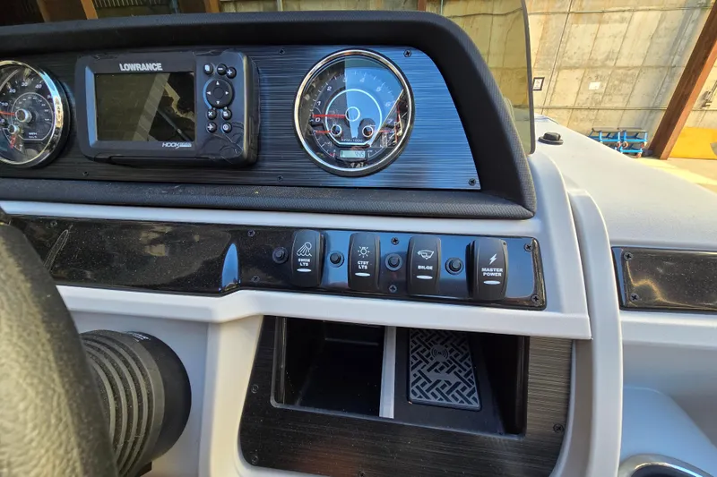 Slide: The Image of Dashboard of 2024 Godfrey Sweetwater 2486 SB with gauges and control switches. - 29