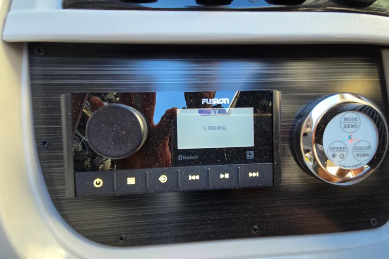 Slide: The Image of 2024 Godfrey Sweetwater 2486 SB boat dashboard with Fusion Bluetooth stereo system. - 34