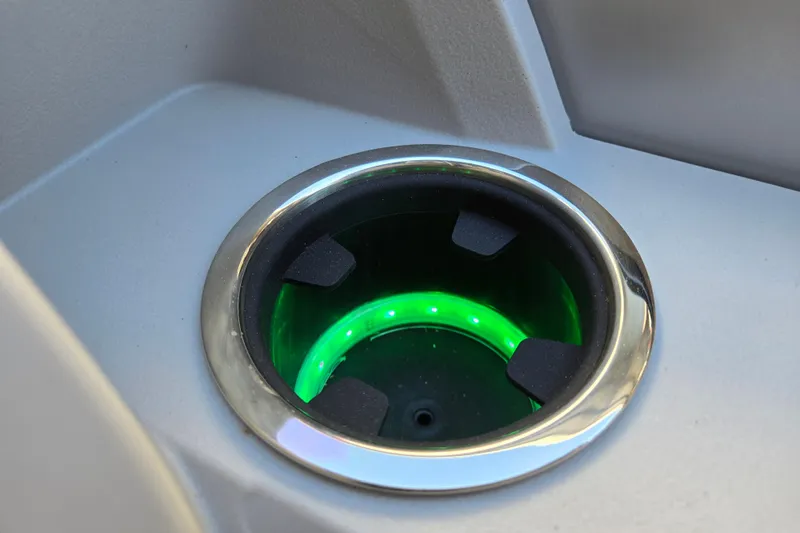 Slide: The Image of Illuminated cup holder on 2024 Godfrey Sweetwater 2486 SB boat, featuring green LED lighting. - 44