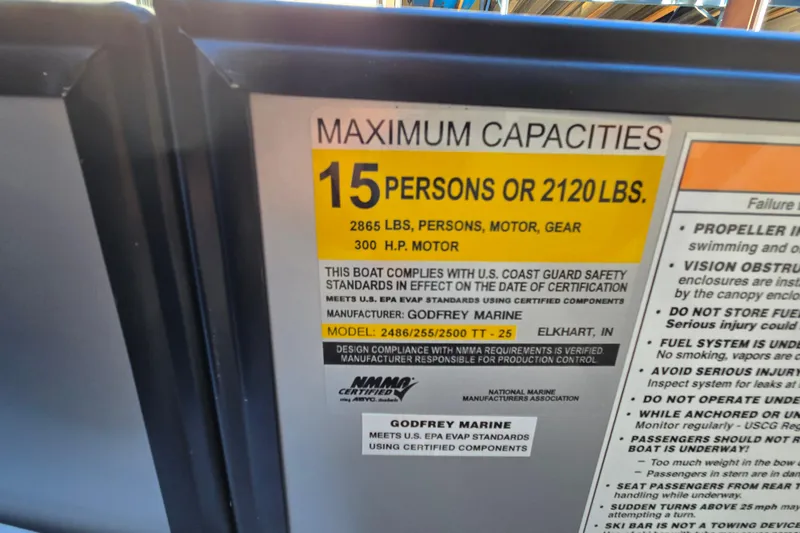 Slide: The Image of Capacity label on 2024 Godfrey Sweetwater 2486 SB boat, max 15 persons or 2120 lbs. - 53