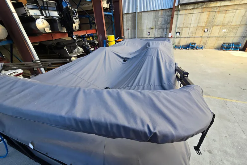 Slide: The Image of Covered 2024 Godfrey Sweetwater 2486 SB pontoon boat in storage facility. - 20