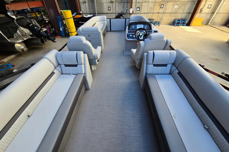 Slide: The Image of Interior of 2024 Godfrey Sweetwater 2486 SB pontoon boat with luxurious seating and helm. - 21