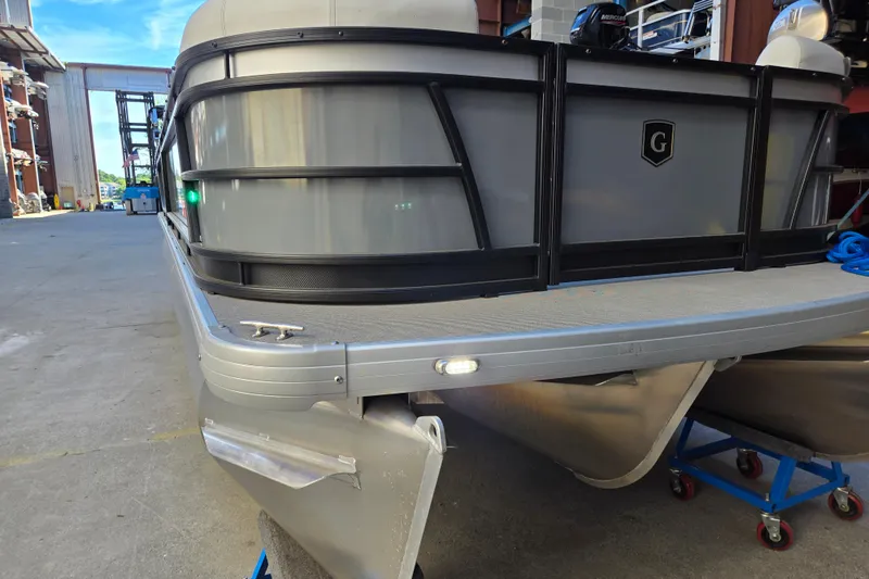 Slide: The Image of 2024 Godfrey Sweetwater 2486 SB pontoon boat in a marina setting. - 15
