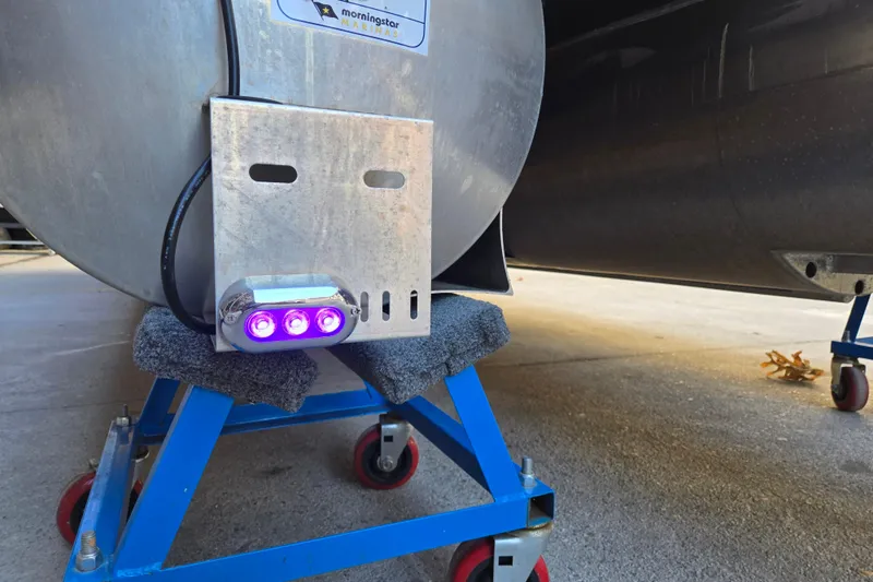 Slide: The Image of 2024 Godfrey Sweetwater 2486 SB pontoon with purple LED lights on a blue stand. - 45