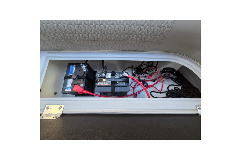 Slide: The Image of 2024 Godfrey Sweetwater 2486 SB battery compartment with wiring and connections. - 48