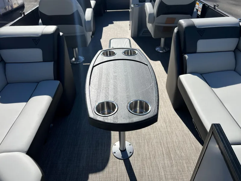 Slide: The Image of Interior of a 2023 Viaggio Lago 22U Tri Toon with gray seating and table. - 22