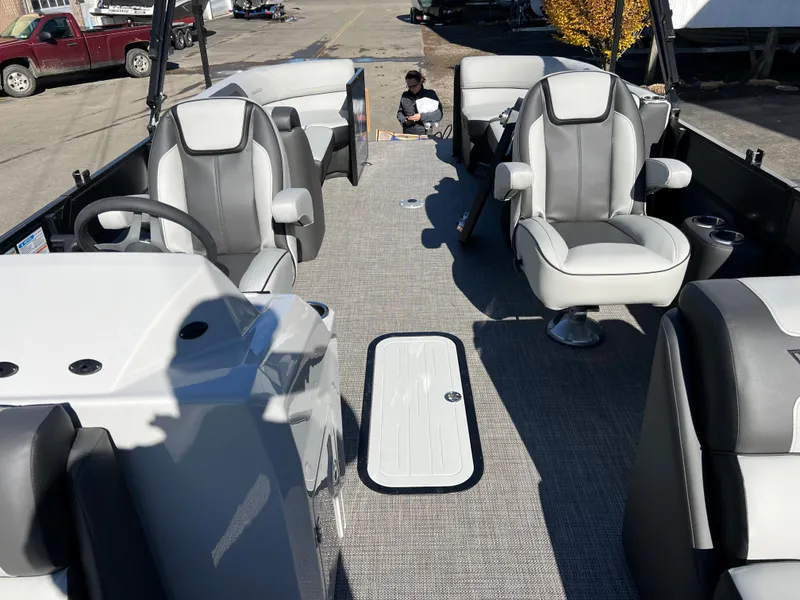 Slide: The Image of Interior view of a Viaggio Lago 22U Tri Toon boat with gray and white seating. - 12