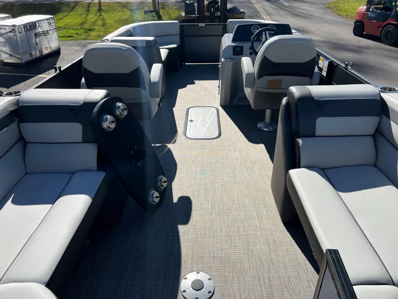 Slide: The Image of Interior of a 2023 Viaggio Lago 22U Tri Toon with gray seating and steering wheel. - 21