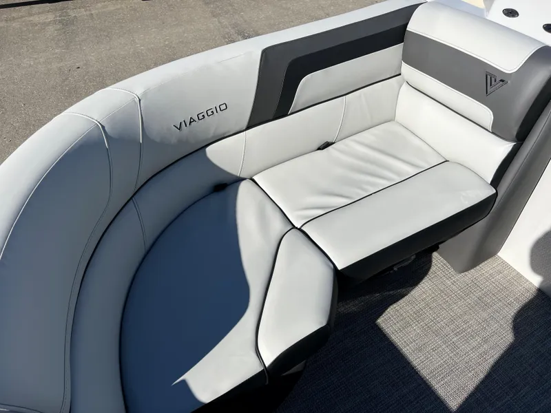 Slide: The Image of The 2023 Viaggio Lago 22U Tri Toon features a sleek, gray seating area with a modern design. - 10