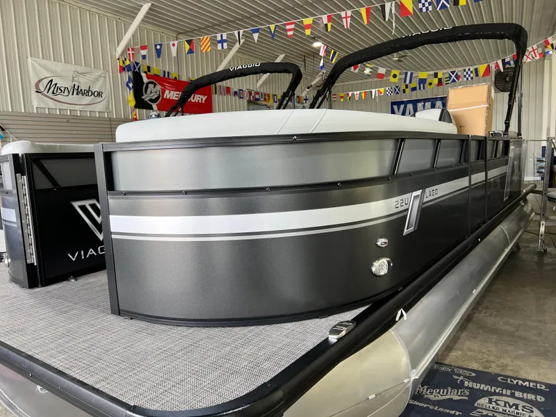 Slide: The Image of 2023 Viaggio Lago 22U Tri Toon with Mercury 150 engine displayed in a showroom. - 4