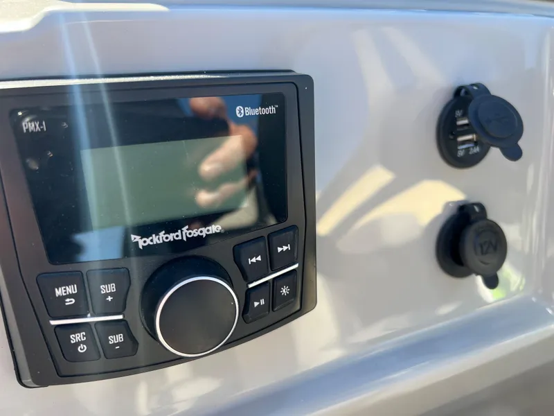 Slide: The Image of Close-up of a boat control panel with Rockford Fosgate Bluetooth system. - 17