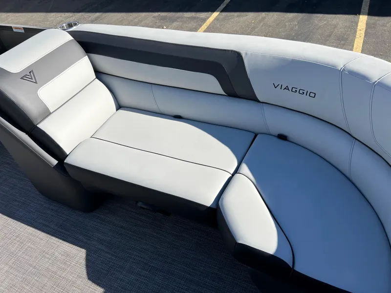 Slide: The Image of The 2023 Viaggio Lago 22U Tri Toon features a sleek gray and black seating area. - 11