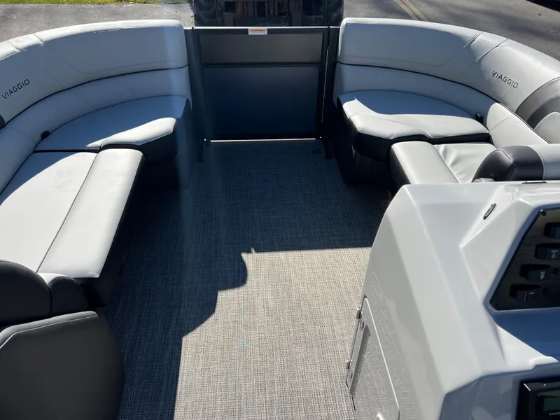 Slide: The Image of Interior of a 2023 Viaggio Lago 22U Tri Toon with gray seating. - 9
