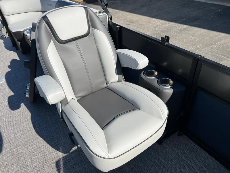 Slide: The Image of A modern, upholstered boat seat with armrests and cup holders on a Viaggio Lago 22U Tri Toon. - 13