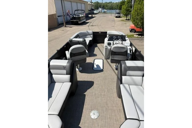 Slide: The Image of 2023 Viaggio Lago 22U Tri Toon boat interior with plush seating and modern dashboard. - 2